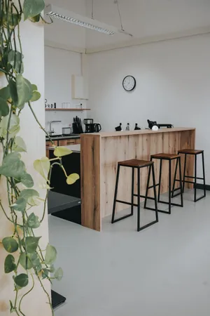 A kitchen with a counter and bar stools