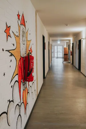 View of a hallway with a comic motif painted on the wall