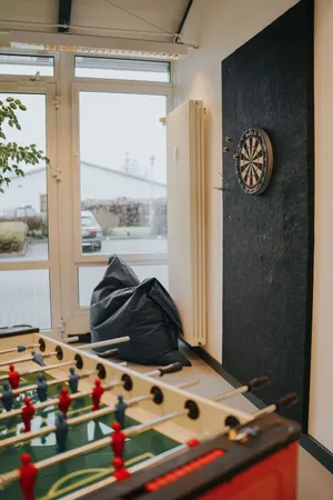 An area with table football, beanbag chairs and a dartboard