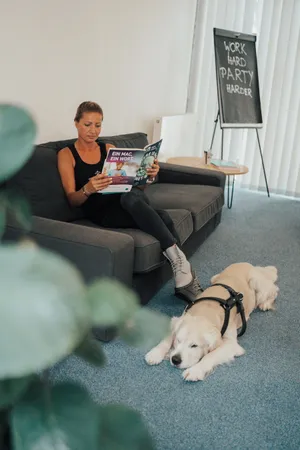 Margarete Lass sitzt auf einem Sofa und ließt eine Zeitschrift im Coworking Space