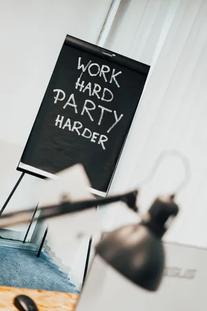 Eine Tafel auf der steht "Work hard, party harder"